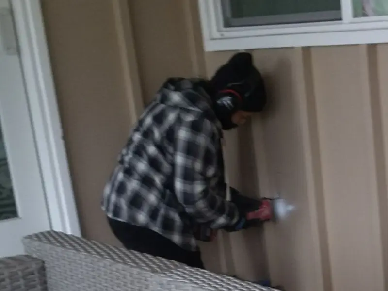 Professional electrician installing an exterior outlet in Quincy